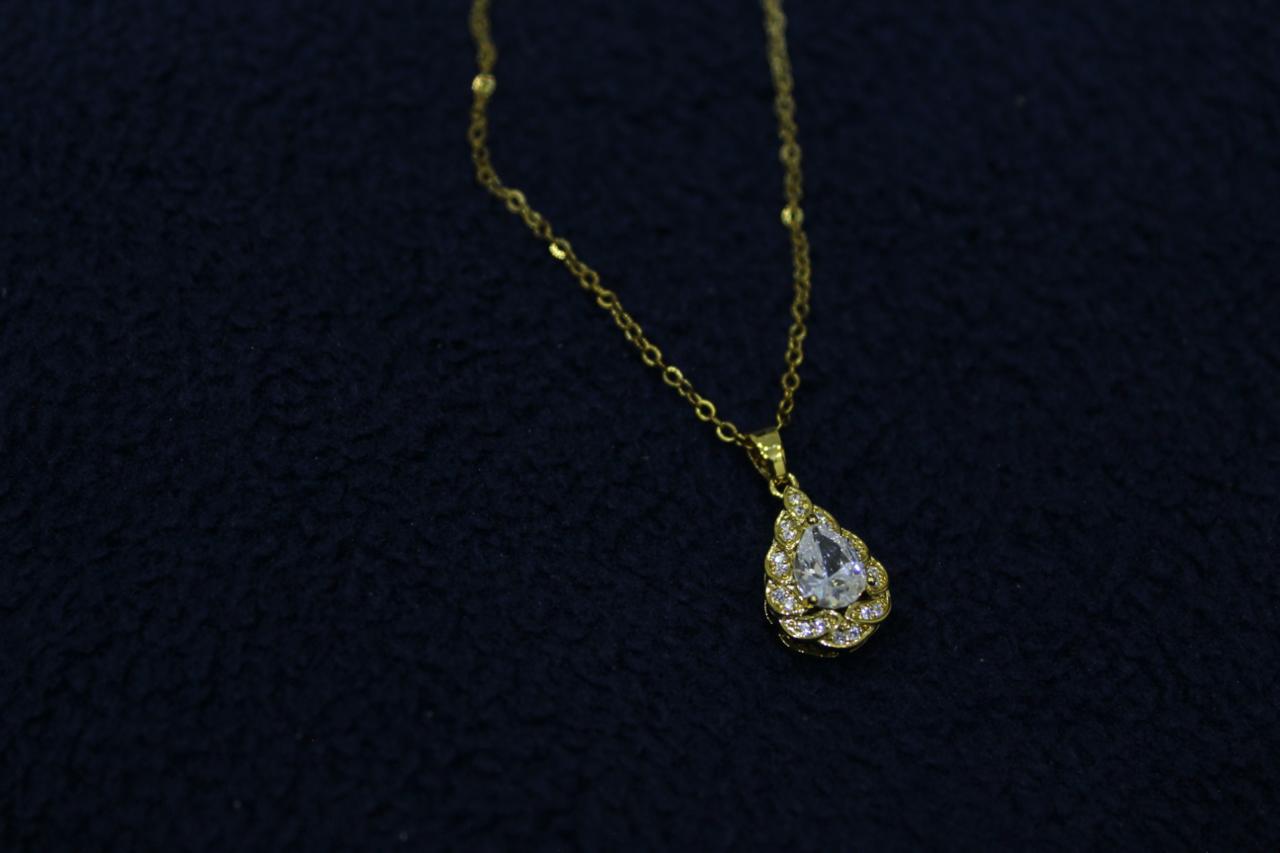 Crystal teardrop pendant necklace product photo on dark background