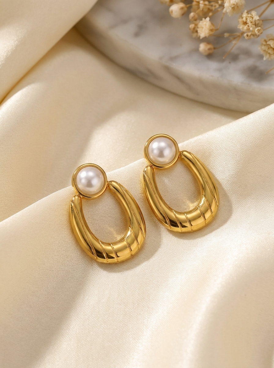 Pearl Top Oval Drop Earrings on cream silk with dried baby's breath and marble tray