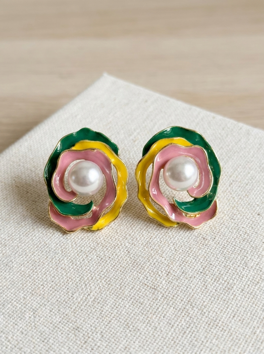 Enamel rose pearl stud earrings on linen fabric close-up
