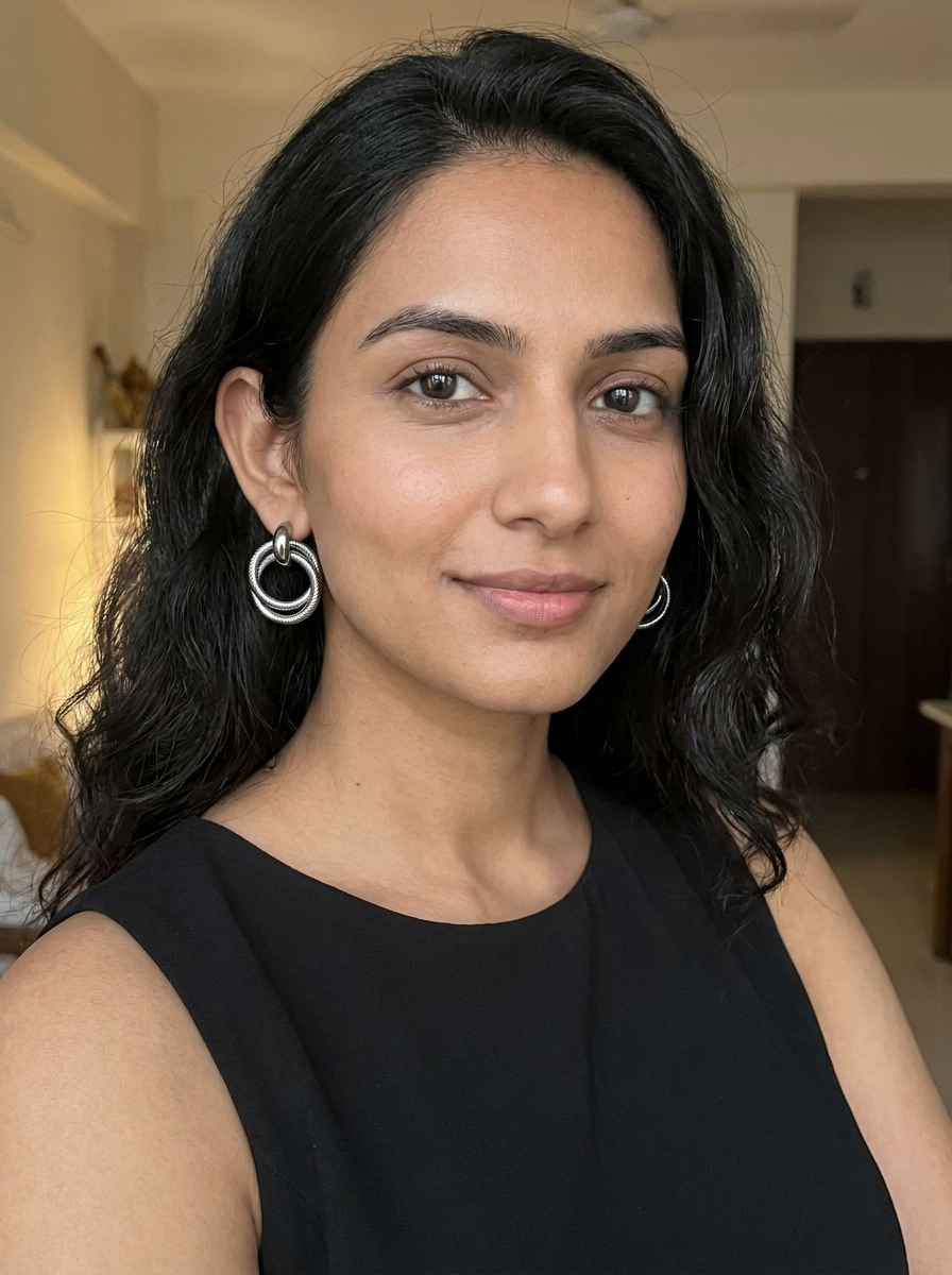 Model wearing gunmetal twisted double hoop earrings with black sleeveless top